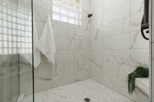 Bathroom featuring a tile shower