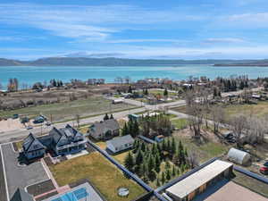 Birds eye view of property with a water and mountain view