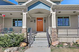 Doorway to property featuring covered porch