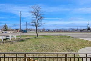 View of yard featuring fence and a mountain view