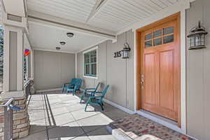 View of exterior entry with a porch