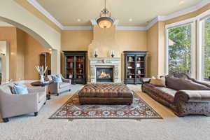 Living room featuring carpet floors and crown molding