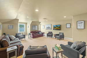 Living room featuring light carpet and lofted ceiling