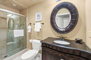 Bathroom featuring vanity, toilet, and walk in shower