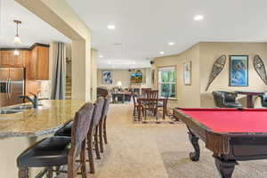 Recreation room featuring sink, light colored carpet, and billiards