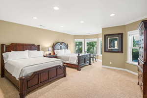 Bedroom featuring crown molding and light colored carpet