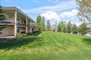 View of yard with a balcony