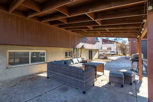 View of patio featuring an outdoor living space and a grill