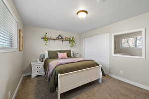 Carpeted bedroom with a closet