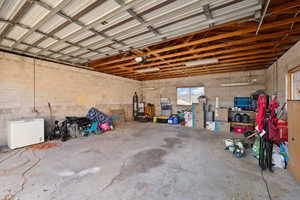 Garage featuring refrigerator and a garage door opener