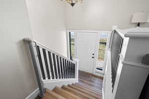 Entryway with hardwood / wood-style flooring and a healthy amount of sunlight