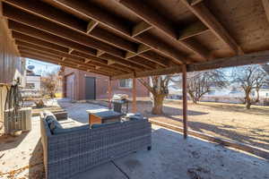 View of patio / terrace featuring area for grilling, central AC unit, an outdoor hangout area, and a storage shed