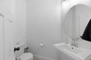 Bathroom with sink, toilet, and tile patterned flooring