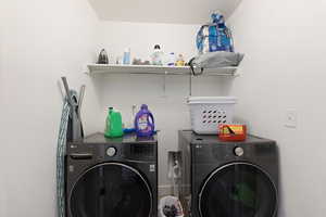 Washroom featuring washing machine and clothes dryer