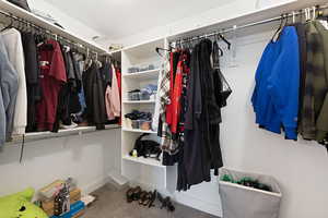 Spacious closet featuring carpet flooring