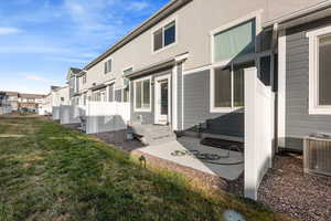 View of property exterior with central AC and a yard