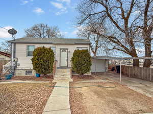 View of front of home with a carport and a garage