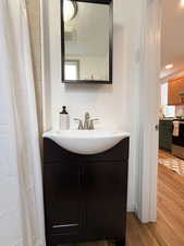 Bathroom with vanity, hardwood / wood-style floors, and a textured ceiling