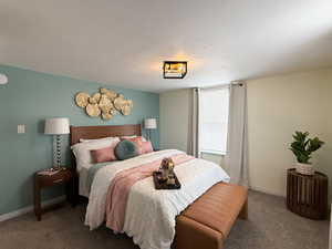 Bedroom featuring carpet floors and a textured ceiling