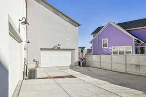 Exterior space featuring straight access two car garage and central AC unit