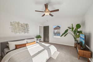 Primary bedroom featuring great windows, vaulted ceiling and ceiling fan