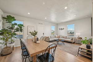 Dining space with light wood-style flooring and large windows