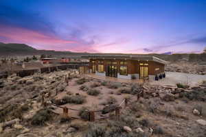 Back house at dusk featuring a mountain view