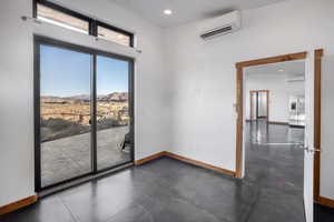 Empty room with a mountain view and a wall mounted AC