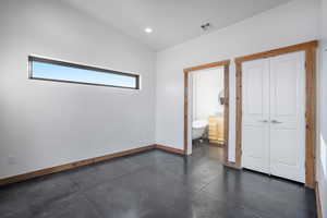 Empty room with plenty of natural light and vaulted ceiling