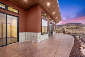 Patio terrace at dusk featuring a mountain view