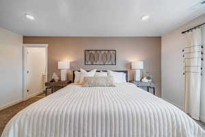 Bedroom featuring light carpet