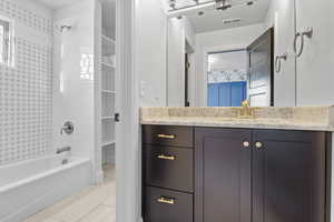 Bathroom featuring vanity and tiled shower / bath combo