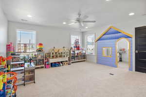 Playroom with carpet floors and ceiling fan