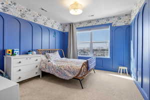 Bedroom with light colored carpet