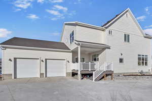 Exterior space with a garage and covered porch