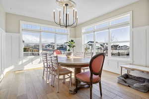 Dining space with an inviting chandelier and light hardwood / wood-style floors