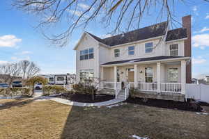 View of front of home with a porch and a front lawn