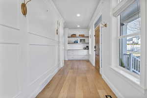 Hall with light hardwood / wood-style floors