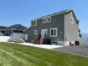 Back of house with a patio area, a yard, cooling unit, and french doors