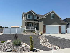 View of front of home with covered porch and a garage