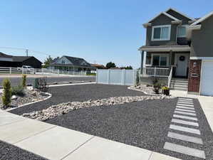 View of yard featuring a garage and covered porch