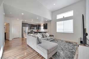 Living room featuring sink, light hardwood / wood-style flooring, and a healthy amount of sunlight