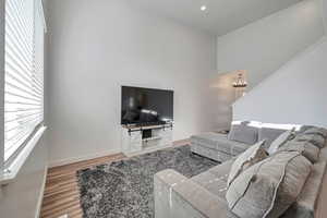 Living room with a notable chandelier and light hardwood / wood-style floors