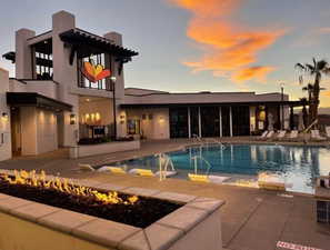 Pool at dusk with a patio area