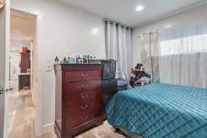 Bedroom with light hardwood / wood-style flooring