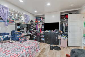 Bedroom with a closet and light hardwood / wood-style flooring