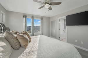 Carpeted bedroom with ceiling fan