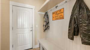 Mudroom with light tile patterned flooring