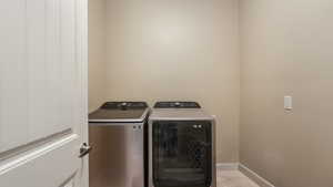 Washroom featuring independent washer and dryer