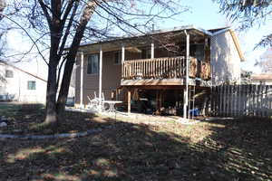 Rear view of house featuring a deck and a patio